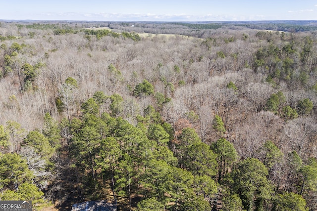 birds eye view of property with a view of trees