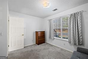 unfurnished room with visible vents, baseboards, and carpet