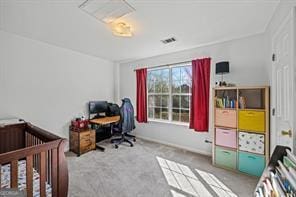 bedroom featuring a nursery area and carpet floors