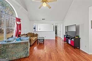 living room with high vaulted ceiling, a ceiling fan, and wood finished floors