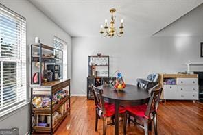 dining room with a notable chandelier and wood finished floors