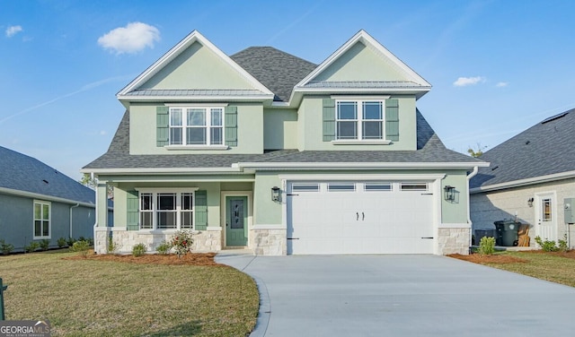 craftsman-style home with metal roof, a porch, a garage, a shingled roof, and a front yard