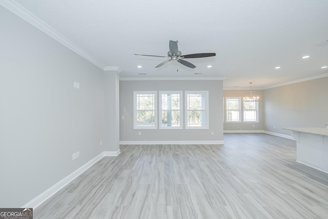 unfurnished living room with light wood-type flooring, baseboards, and crown molding