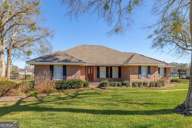 single story home with brick siding, roof with shingles, and a front yard