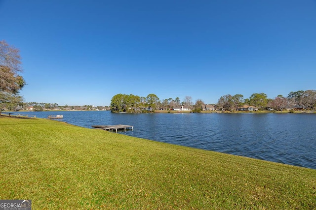 dock area featuring a water view and a yard