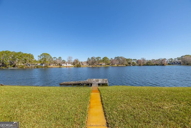 view of dock featuring a water view and a yard