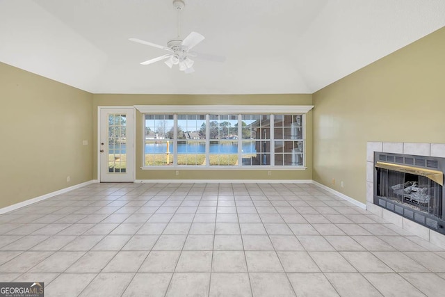 unfurnished living room with a water view, a fireplace, baseboards, and lofted ceiling