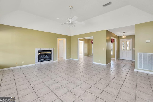 unfurnished living room featuring vaulted ceiling, light tile patterned floors, a tiled fireplace, and visible vents