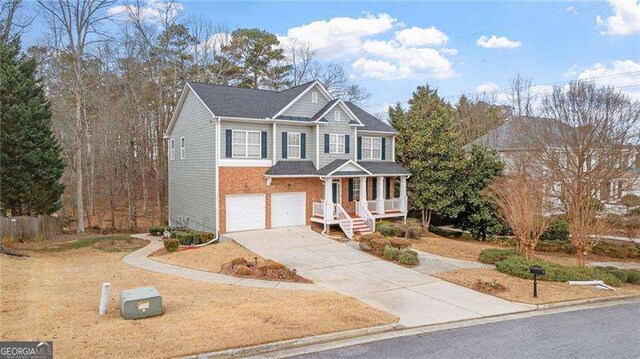 1657 Stilesboro Ridge Dr, Kennesaw, GA 30152 - view of front of home featuring concrete driveway, an attached garage, covered porch, and brick siding