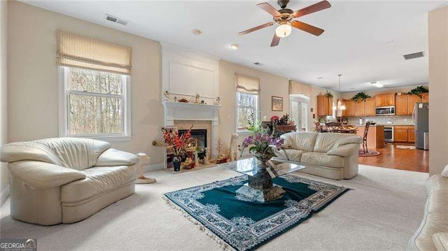 1657 Stilesboro Ridge Dr, Kennesaw, GA 30152 - living area with ceiling fan, a fireplace, light carpet, and beverage cooler
