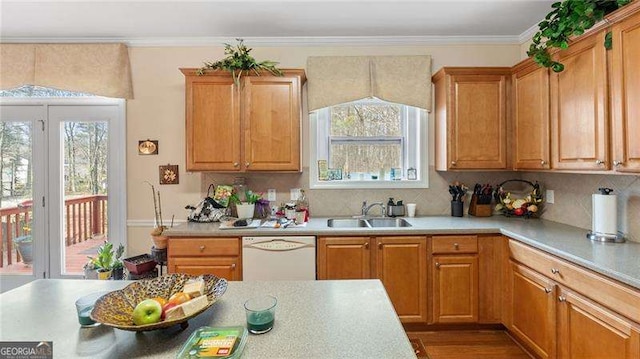 1657 Stilesboro Ridge Dr, Kennesaw, GA 30152 - kitchen with dishwasher, light countertops, crown molding, tasteful backsplash, and brown cabinetry