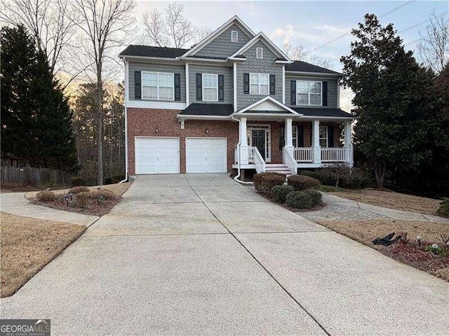 1657 Stilesboro Ridge Dr, Kennesaw, GA 30152 - view of front facade with covered porch, driveway, an attached garage, and brick siding