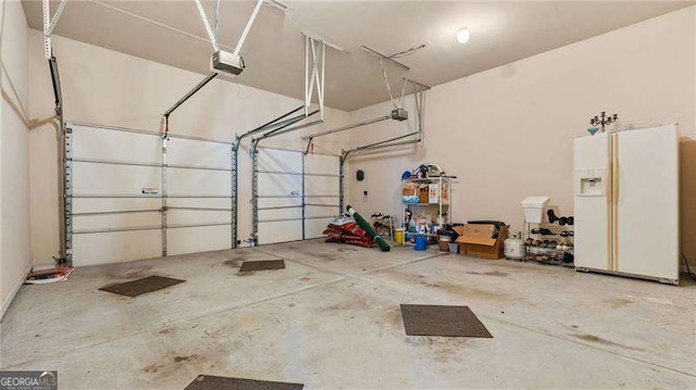 1657 Stilesboro Ridge Dr, Kennesaw, GA 30152 - garage with white refrigerator with ice dispenser and a garage door opener