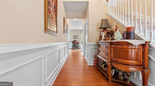 1657 Stilesboro Ridge Dr, Kennesaw, GA 30152 - hall featuring wood finished floors, a decorative wall, and a wainscoted wall