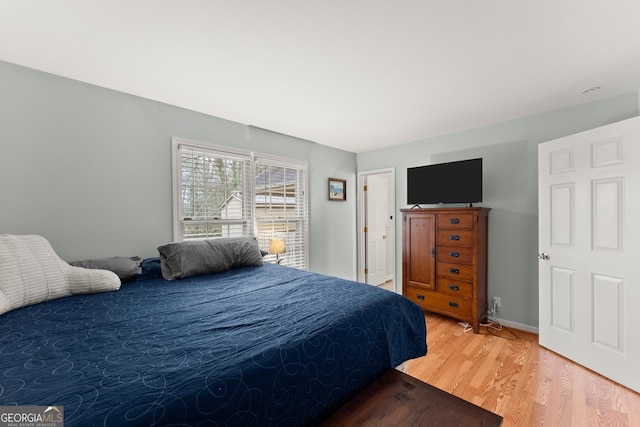 bedroom featuring wood finished floors and baseboards