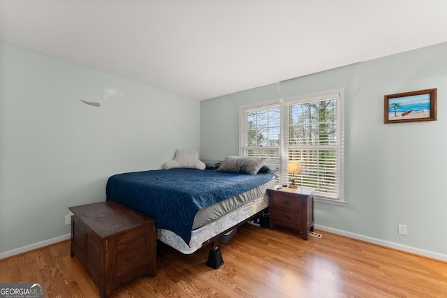 bedroom featuring light wood-type flooring and baseboards