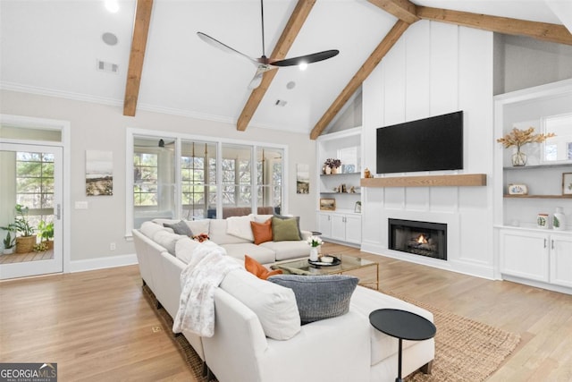 living room featuring light wood finished floors, a large fireplace, visible vents, beamed ceiling, and built in shelves