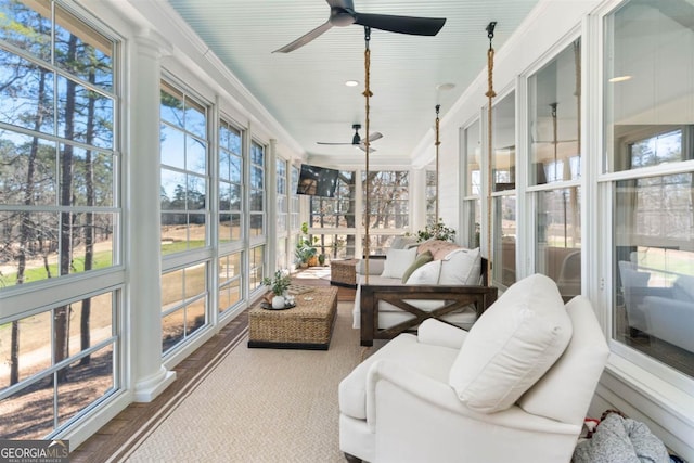 sunroom featuring ceiling fan