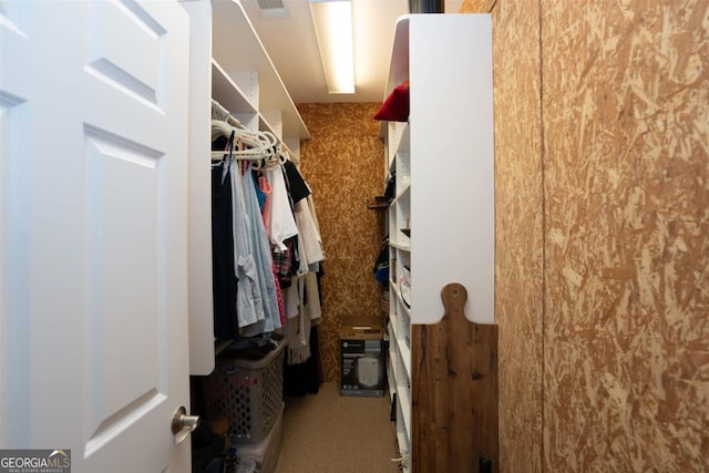 spacious closet with carpet and visible vents