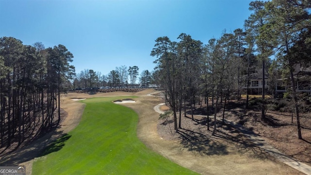 view of community with a yard and golf course view