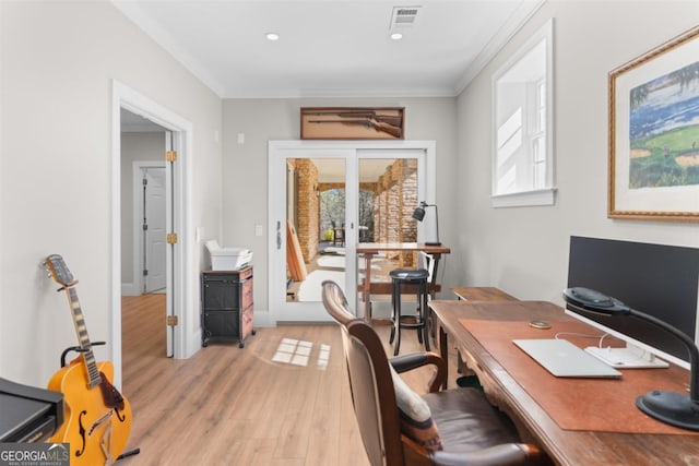 home office with light wood-type flooring, french doors, visible vents, and crown molding