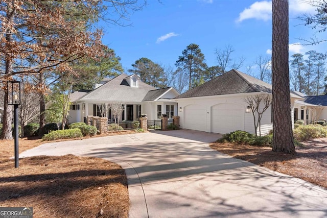 view of front of home with concrete driveway and an attached garage