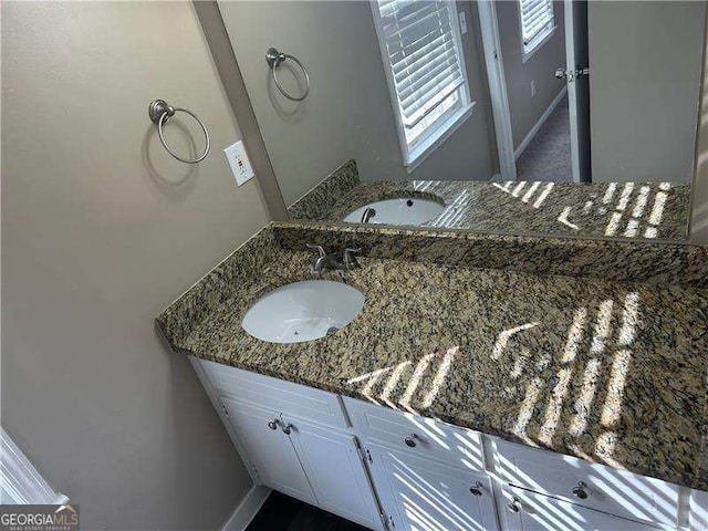 bathroom featuring baseboards and vanity