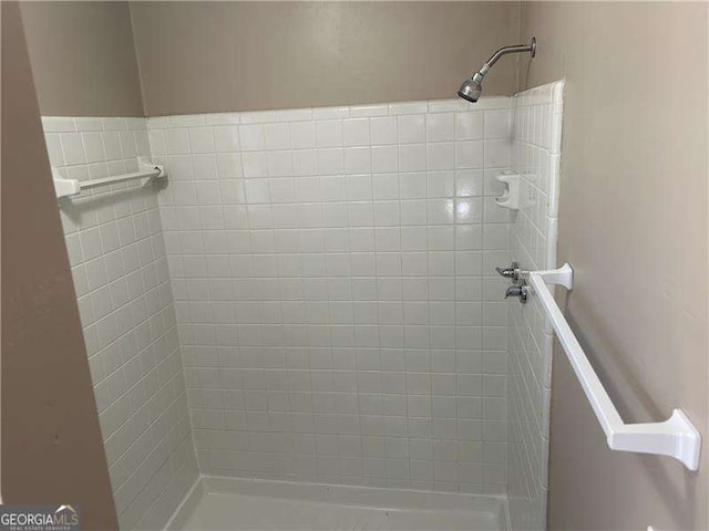 bathroom with tiled shower