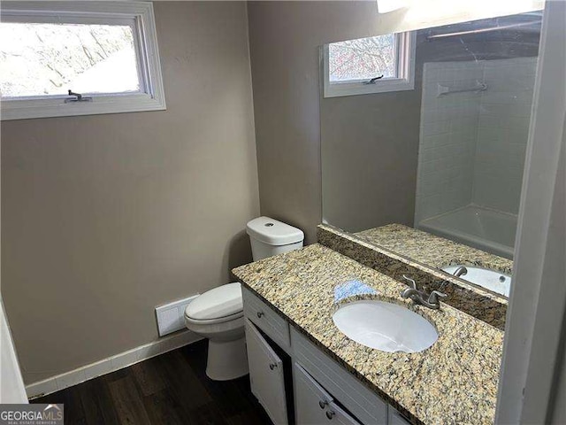 bathroom featuring vanity, wood finished floors, toilet, and baseboards