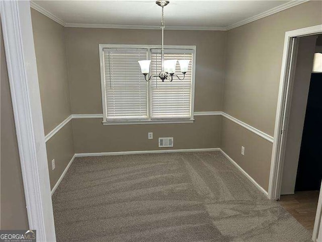 unfurnished dining area with baseboards, ornamental molding, visible vents, and an inviting chandelier