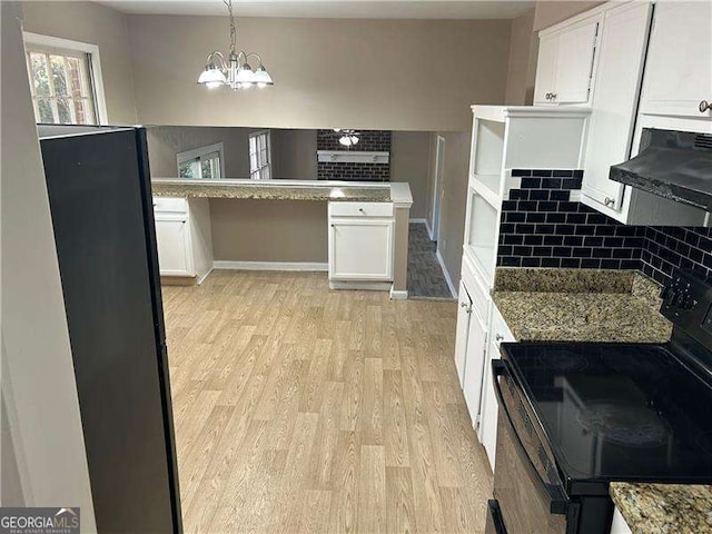 kitchen featuring decorative light fixtures, light wood-type flooring, white cabinets, and black electric range oven