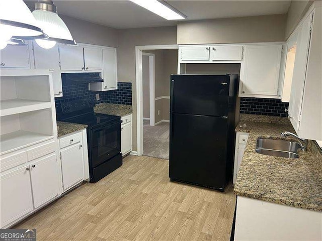 kitchen with light wood-style floors, white cabinetry, a sink, and black appliances