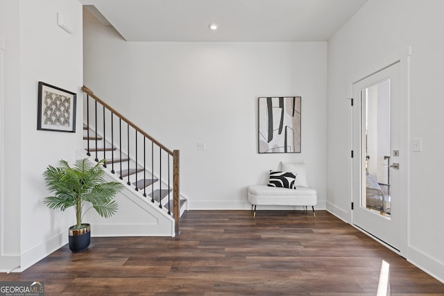 foyer with dark wood-style floors, recessed lighting, baseboards, and stairs