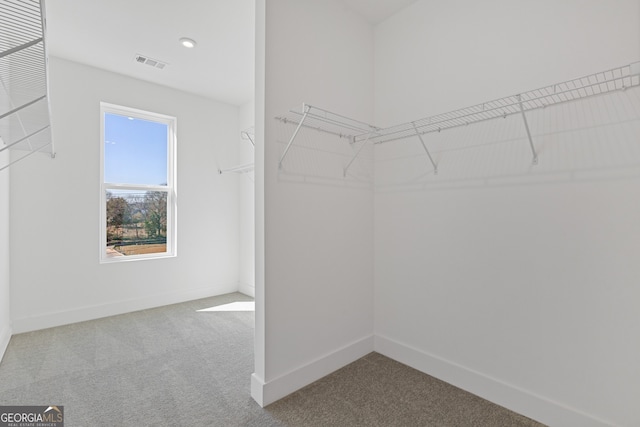 walk in closet featuring carpet flooring and visible vents