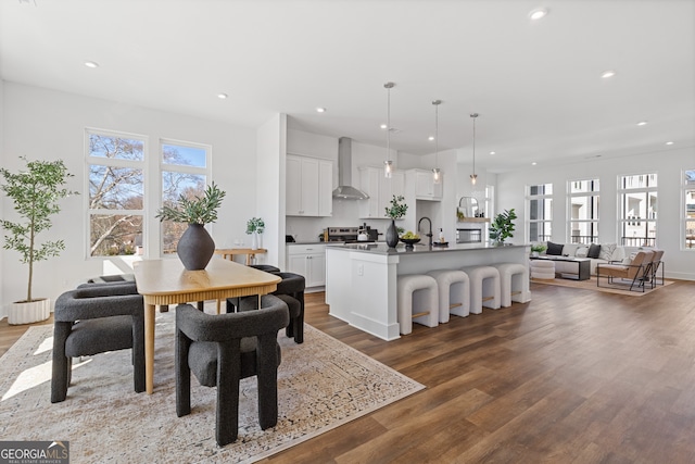 dining space with dark wood-style floors, recessed lighting, and a healthy amount of sunlight