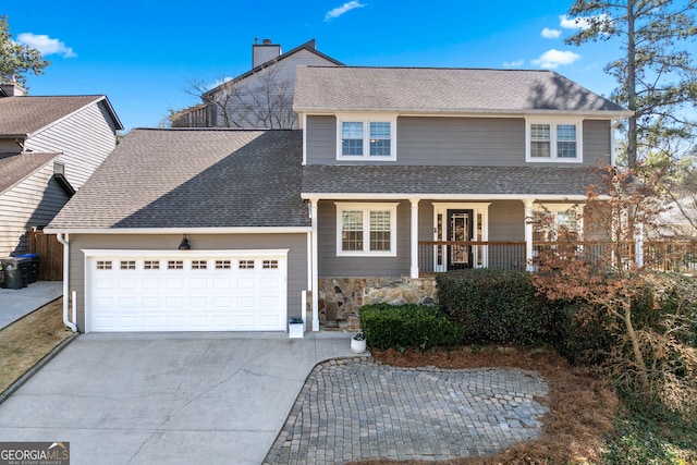 traditional-style house featuring driveway, stone siding, roof with shingles, an attached garage, and covered porch