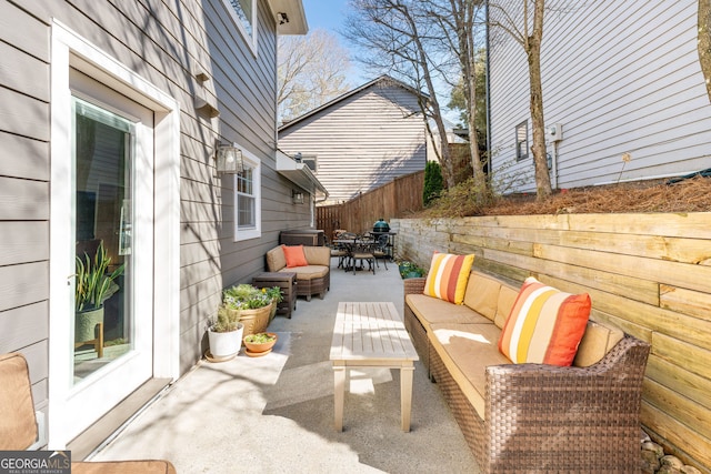 view of patio / terrace with outdoor dining area, fence, and an outdoor hangout area