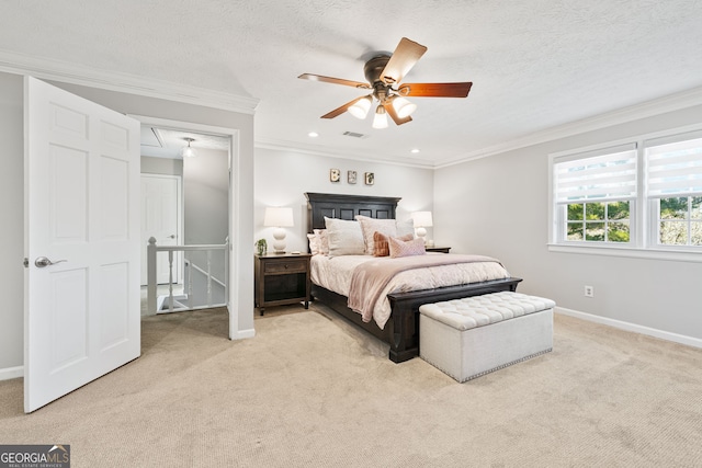 bedroom featuring light carpet, attic access, a textured ceiling, and crown molding