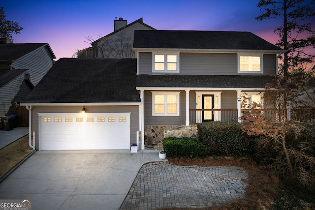 traditional home with a garage, driveway, a chimney, roof with shingles, and a porch