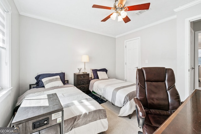 bedroom with carpet floors, visible vents, ornamental molding, and a ceiling fan