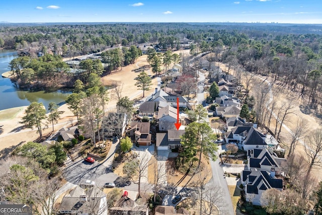 aerial view with a residential view, a water view, and a forest view