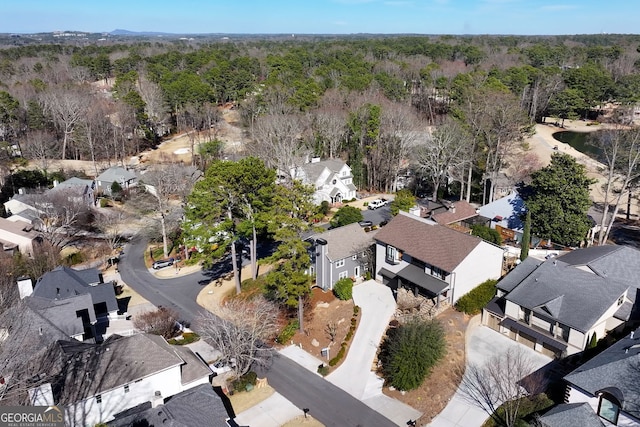 bird's eye view featuring a forest view and a residential view