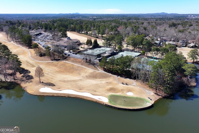 drone / aerial view featuring a water view and a wooded view