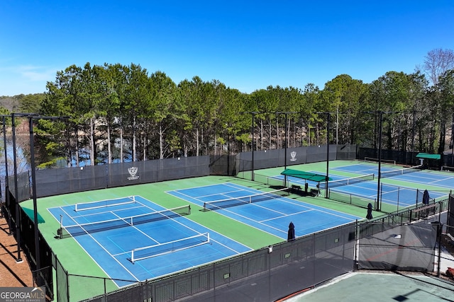 view of tennis court featuring fence