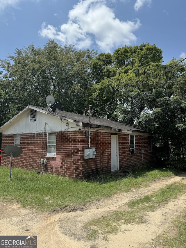 view of property exterior with brick siding