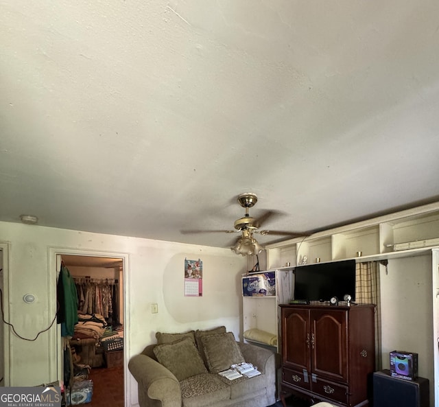 living area featuring a ceiling fan