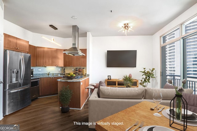 kitchen featuring brown cabinetry, dark wood-style flooring, a sink, stainless steel refrigerator with ice dispenser, and exhaust hood