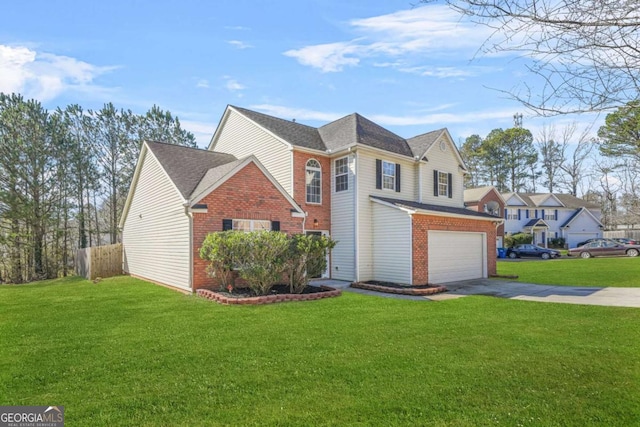 traditional-style house featuring driveway, a garage, fence, a front yard, and brick siding