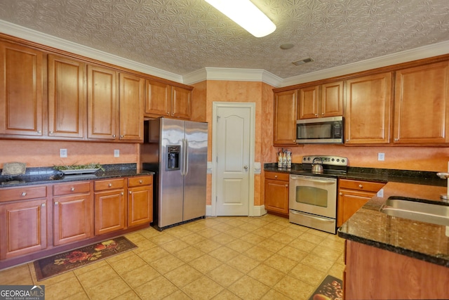 kitchen featuring visible vents, brown cabinetry, an ornate ceiling, appliances with stainless steel finishes, and a sink