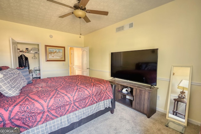 bedroom with light colored carpet, a closet, visible vents, and a textured ceiling